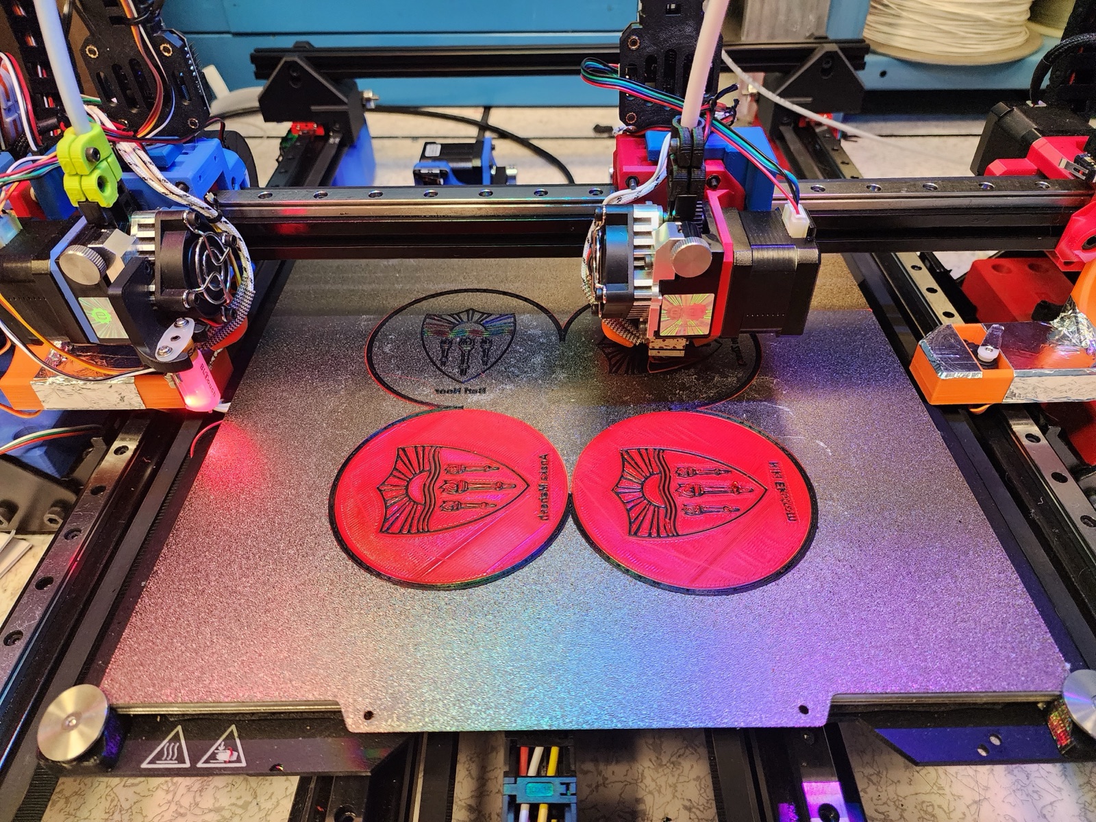 Both extruders printing coasters simultaneously